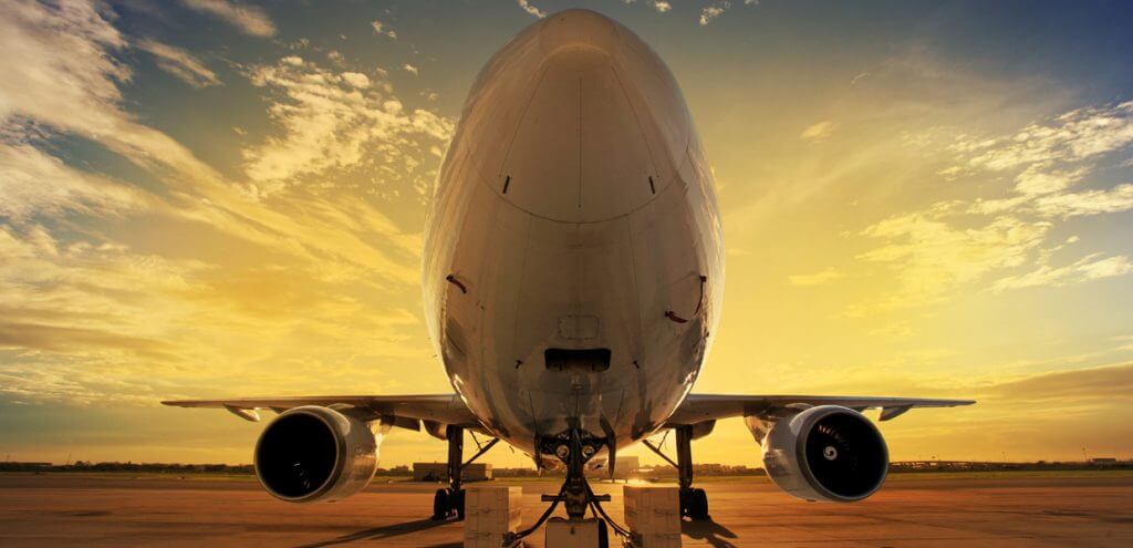 Cargo aircraft on an airport apron at sunset
