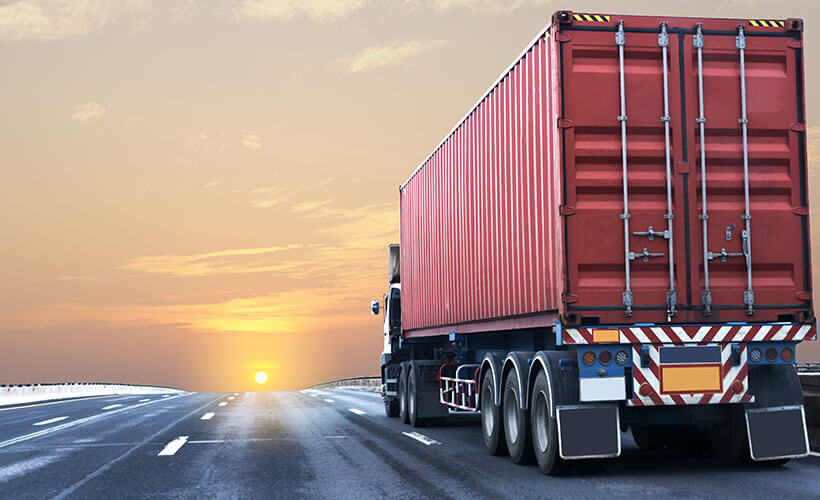 Container truck travelling along a highway